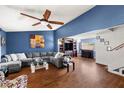 Spacious living room with hardwood floors, a large sectional sofa, and a built in bar at 4322 Satinwood Dr, Las Vegas, NV 89147