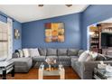 Comfortable living room featuring a large sectional sofa, hardwood floors, and stylish decor at 4322 Satinwood Dr, Las Vegas, NV 89147