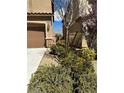 Well-maintained landscaping adorns the front of this home at 486 Stonegate Meadow Ave, Las Vegas, NV 89178