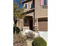 Charming two-story home with a landscaped front yard and inviting entrance at 486 Stonegate Meadow Ave, Las Vegas, NV 89178