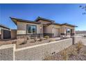 Charming single-story home with neutral colors, brick driveway, and well-maintained desert landscaping at 498 Copper Falcon Ave, Henderson, NV 89011