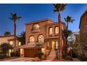 Attractive two-story home with stone accents, arched windows, balconies and steps leading to the entryway at 6075 Belvedere Canyon Ave, Las Vegas, NV 89139