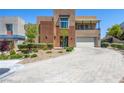 Beautiful two-story home featuring desert landscaping, three-car garage and neutral stucco at 7222 Pulsar Mesa Ct, Las Vegas, NV 89148