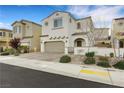 Inviting two-story home with desert landscaping, a brick driveway, and a front entrance archway at 8043 Tank Loop St, Las Vegas, NV 89166