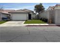 Cozy single-Gathering home with desert landscaping, a paved driveway, and a secure two-car garage at 8419 W Rochelle Ave, Las Vegas, NV 89147