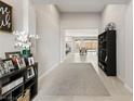 Bright foyer featuring neutral tones and views of the open concept living area and backyard at 8575 Nicholas James Ave, Las Vegas, NV 89143