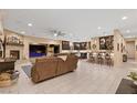 Open-concept living space with fireplace, bar area, and seamless flow to the outdoor patio at 9117 Hickam Ave, Las Vegas, NV 89129