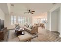 Open-concept living room boasts plenty of natural light and wood-look flooring at 10235 Tresor Ct, Las Vegas, NV 89135