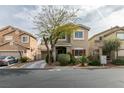 Charming two-story home with a landscaped front yard and a well-manicured lawn at 10450 Kepler Cascades St, Las Vegas, NV 89141