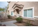 Charming front entrance featuring well-maintained landscaping with decorative rock and bushes around the facade at 10643 Petricola St # 103, Las Vegas, NV 89183