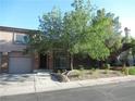 Charming two-story home with a front yard, desert landscaping, and an attached garage at 1607 Colloquium Dr # 0, Henderson, NV 89014