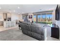 Bright living room featuring an open floorplan, lots of natural light, and modern finishes, and backyard views at 180 Native Stone St, Las Vegas, NV 89138