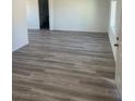 Bright living room featuring wood-style floors, fresh paint, and ample natural light at 2036 Canosa Ave, Las Vegas, NV 89104