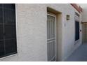 Side exterior showing a textured facade with a well-lit entrance and a window at 2048 Mesquite Ln # 303, Laughlin, NV 89029