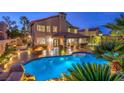 Lush backyard with a sparkling pool, covered patio, and ample space for outdoor entertaining at 2232 Barchetta Dr, Las Vegas, NV 89134