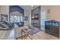 Bright living room featuring a fireplace, modern furniture, and a large window with shutters at 2232 Barchetta Dr, Las Vegas, NV 89134