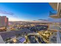 Elevated perspective of the bustling Las Vegas Strip with a stunning mountain backdrop, viewed from a high-rise balcony at 2700 Las Vegas Blvd # 1301, Las Vegas, NV 89109