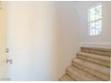 Bright entryway with carpeted stairs leading to the upper level and a large window at 2801 N Rainbow Blvd # 238, Las Vegas, NV 89108