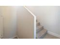 Simple carpeted staircase ascends along a white wall with white trim details at 2801 N Rainbow Blvd # 238, Las Vegas, NV 89108
