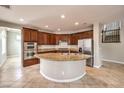 Gourmet kitchen features a large island, granite countertops, and stainless steel appliances at 3725 Moonshine Falls Ave, North Las Vegas, NV 89085