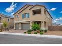 Charming two-story home featuring a 3-car garage, brick paver driveway, desert landscaping and an open air covered balcony at 3909 Grazing Gazelle Ave, North Las Vegas, NV 89084