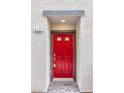 A close-up of a bright red front door with gray trim and the house number '4125' at 4125 Venus Falls Ave, North Las Vegas, NV 89084