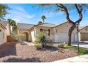 Inviting single-story home with desert landscaping, tile roof, and covered entryway enhancing its curb appeal at 4443 Verdiccio Ave, Las Vegas, NV 89141