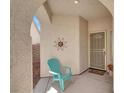 Cozy front porch with a decorative sun and turquoise chair creating a welcoming entryway at 4443 Verdiccio Ave, Las Vegas, NV 89141