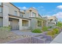 Contemporary townhome featuring drought-tolerant landscaping and paved walkway to the front entry at 502 Sonoma Range St, Las Vegas, NV 89138