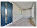 Charming front porch featuring a stylish blue front door and neutral brick flooring at 502 Sonoma Range St, Las Vegas, NV 89138