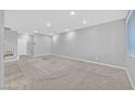 Spacious living room with neutral carpet, recessed lighting, and staircase access at 502 Sonoma Range St, Las Vegas, NV 89138