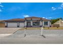 Charming home exterior showcases a well-manicured front yard and inviting entryway at 5601 Mary Lou St, Pahrump, NV 89061