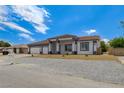 Lovely home exterior with a three-car garage and a gravel front yard at 5601 Mary Lou St, Pahrump, NV 89061