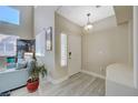 Inviting entryway with tile floors, a front door, and a glimpse of the living room at 5824 Farmhouse Ct, Las Vegas, NV 89141