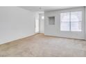 Spacious living room with large windows and neutral carpet, ready for personal touches at 5855 Valley Dr # 2020, North Las Vegas, NV 89031