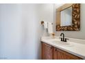 The half bath features a modern mirror, elegant fixtures, and a pristine white countertop at 6120 Crystal Cascade St, Las Vegas, NV 89130
