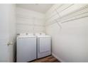Functional laundry room with modern washer, dryer, and plenty of shelving for storage at 6120 Crystal Cascade St, Las Vegas, NV 89130