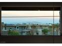 Magnificent view of the Las Vegas cityscape from the balcony, framed by contemporary homes and palm trees at 6197 Jewel Vista St, Las Vegas, NV 89135