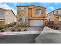 Two-story home showcasing a well-maintained front yard and brick driveway leading to a two-car garage at 632 Loyalty Ct, Henderson, NV 89011