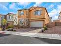 Two-story home featuring a well-maintained front yard, brick accents, and a two-car garage at 632 Loyalty Ct, Henderson, NV 89011