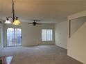 Spacious living room with carpet, ceiling fan, and sliding glass doors leading to the backyard at 6462 Saddle Up Ave # 103, Henderson, NV 89011