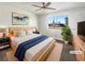 Staged bedroom featuring a large window, ceiling fan, and stylish decor at 6479 Gunderson Blvd, Las Vegas, NV 89103
