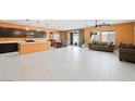 Open concept living room with modern tile flooring and a wall of sliding glass doors at 6602 Windy Palm St, North Las Vegas, NV 89086