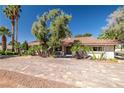 Charming single-story home featuring mature trees, desert landscaping and a brick paved driveway at 800 Kenny Way, Las Vegas, NV 89107