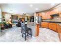 Open kitchen featuring granite counters, stainless steel appliances and breakfast bar seating that flows into the living room at 8224 Chimney Bluffs St, North Las Vegas, NV 89085