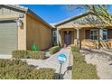 Inviting covered front porch, complete with a Ring doorbell, on a tan, single-story home at 8514 Garnet Lake Ave, Las Vegas, NV 89113