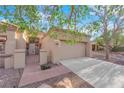 Welcoming home with a gated front entry, mature trees, and a convenient two-car garage at 9013 Litchfield Ave, Las Vegas, NV 89134