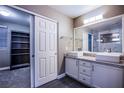 Stylish bathroom features double sinks, granite countertop and open shelving in adjacent room at 913 Evening Fawn Dr, North Las Vegas, NV 89031