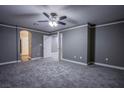 Spacious bedroom offers neutral walls, plush carpeting and a ceiling fan for added comfort at 913 Evening Fawn Dr, North Las Vegas, NV 89031