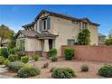 Charming two-story home with a landscaped front yard and brick fence at 10247 Gladstone Peak St, Las Vegas, NV 89166